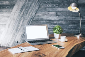 desk with laptop and adjustable lamp 